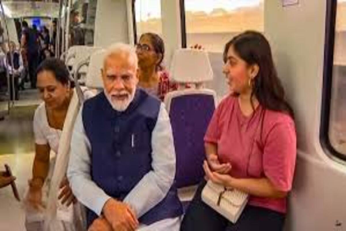 PM Modi interacting with a commoner during a ride in Delhi metro